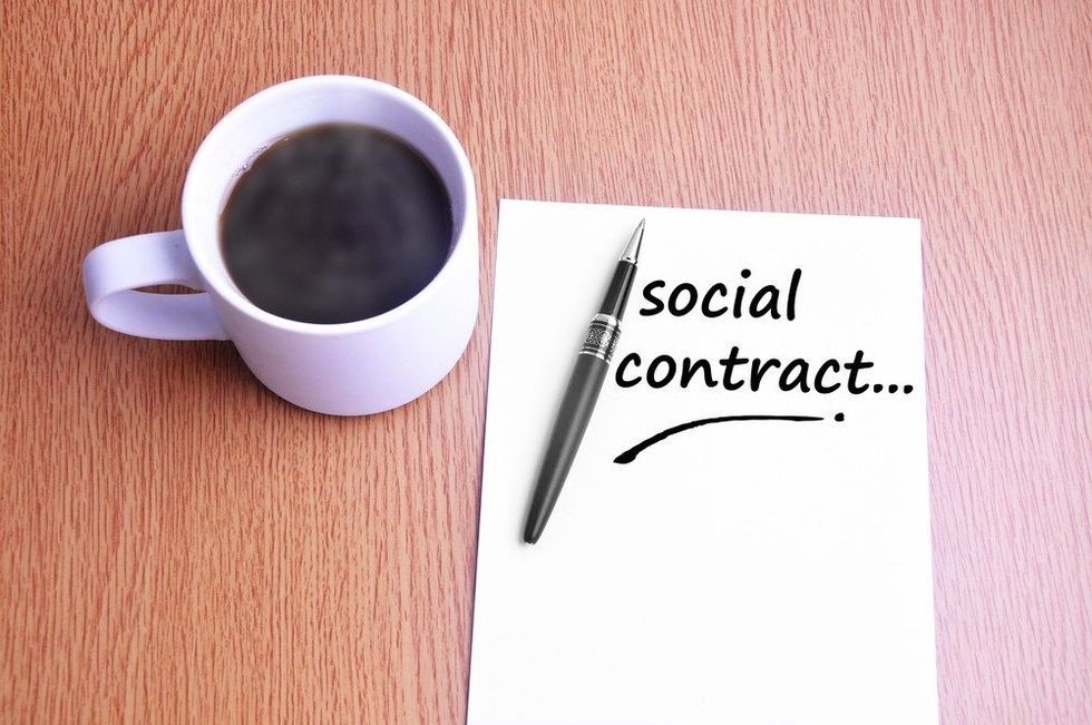Steamy Coffee And Black Pen With White Paper Writing Social Contract On The Table.