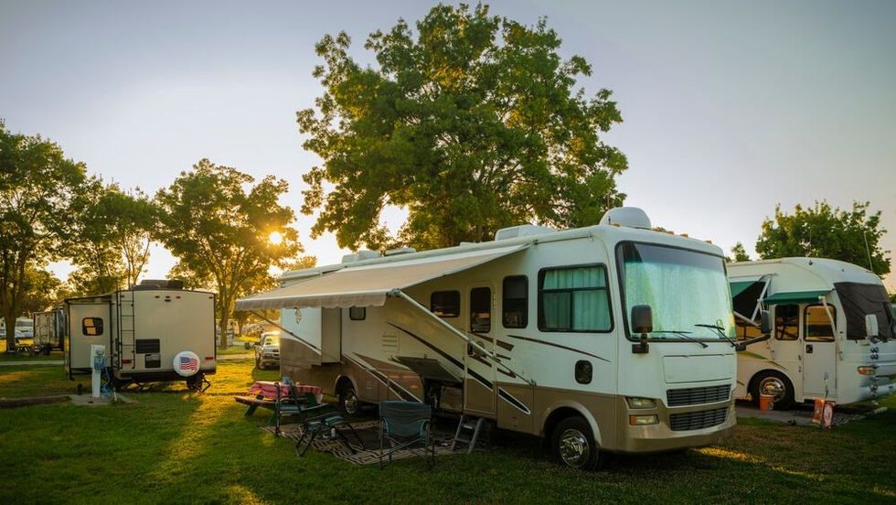Sun going down at the Rv park with lights on the motor home