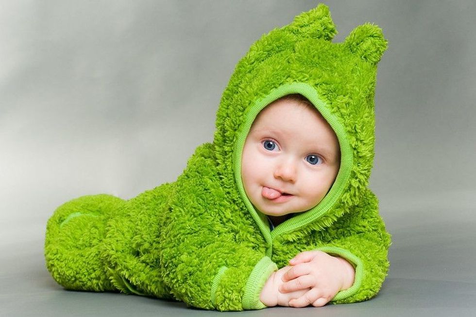 Sweet cute baby dressed in a frog suit.