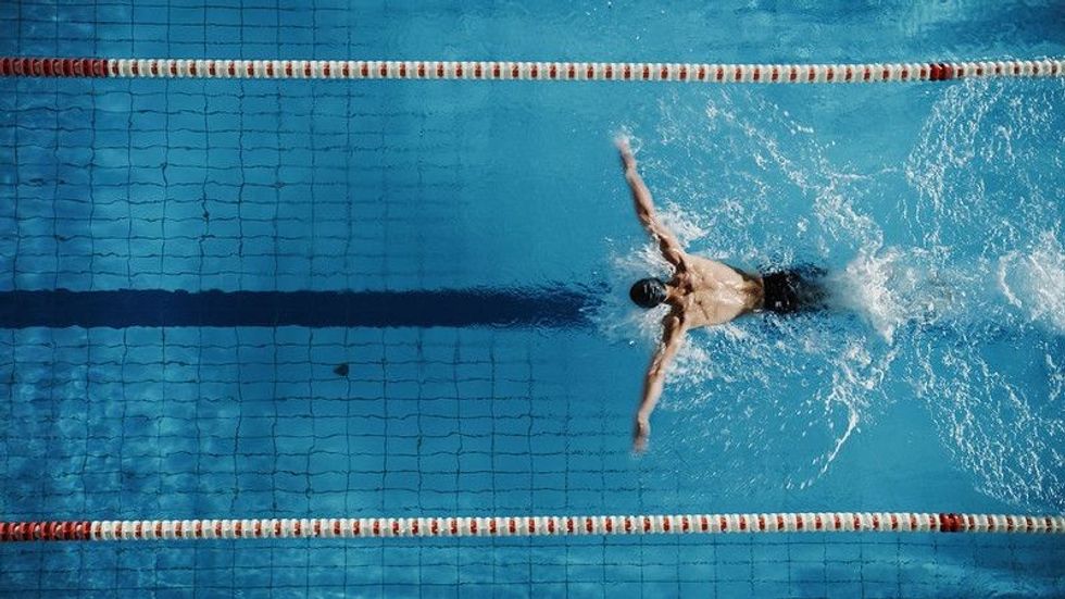 Swimmer in the pool in wide arms action