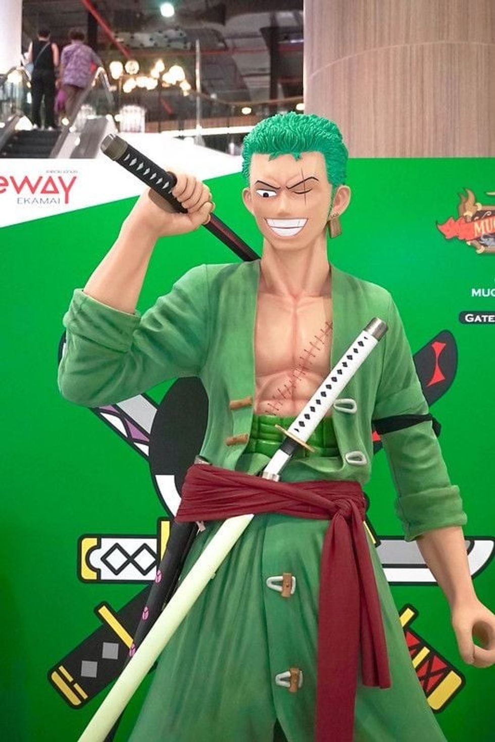 Swordsman statue in green outfit