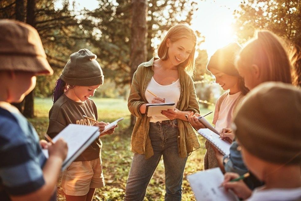 Teacher interacting with group of school kids