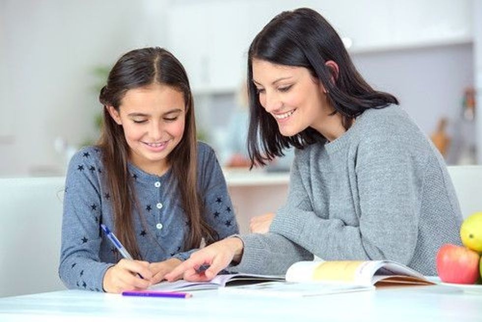 Teacher teaching her student