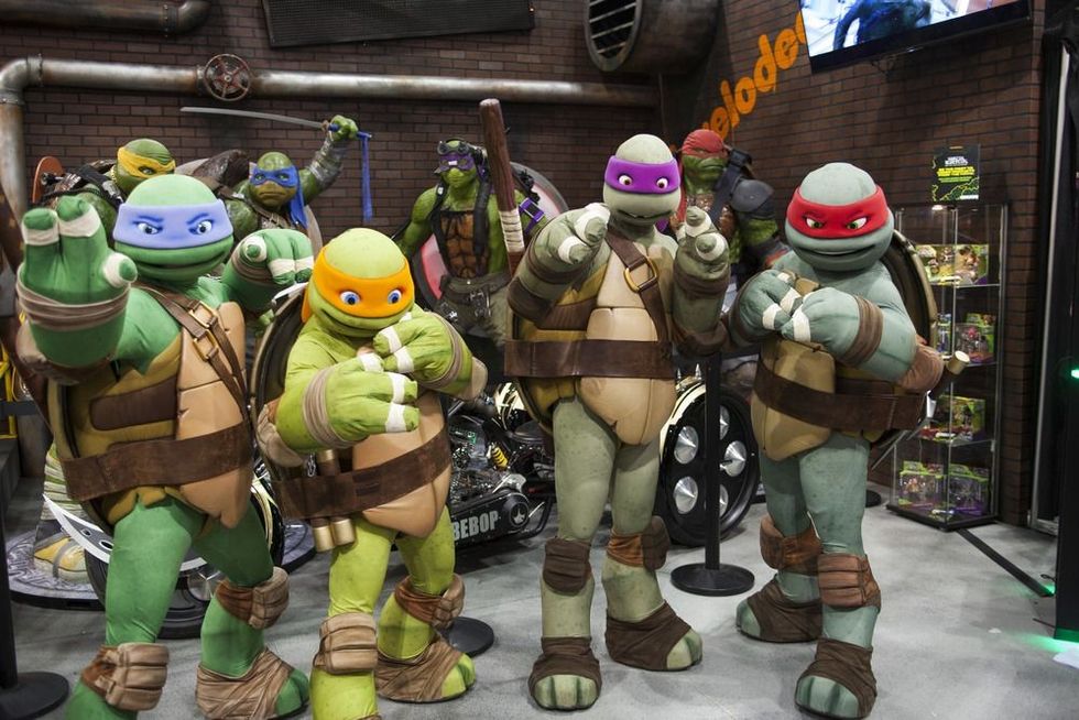 Teenage Mutant Ninja Turtles pose for a photo at their booth.