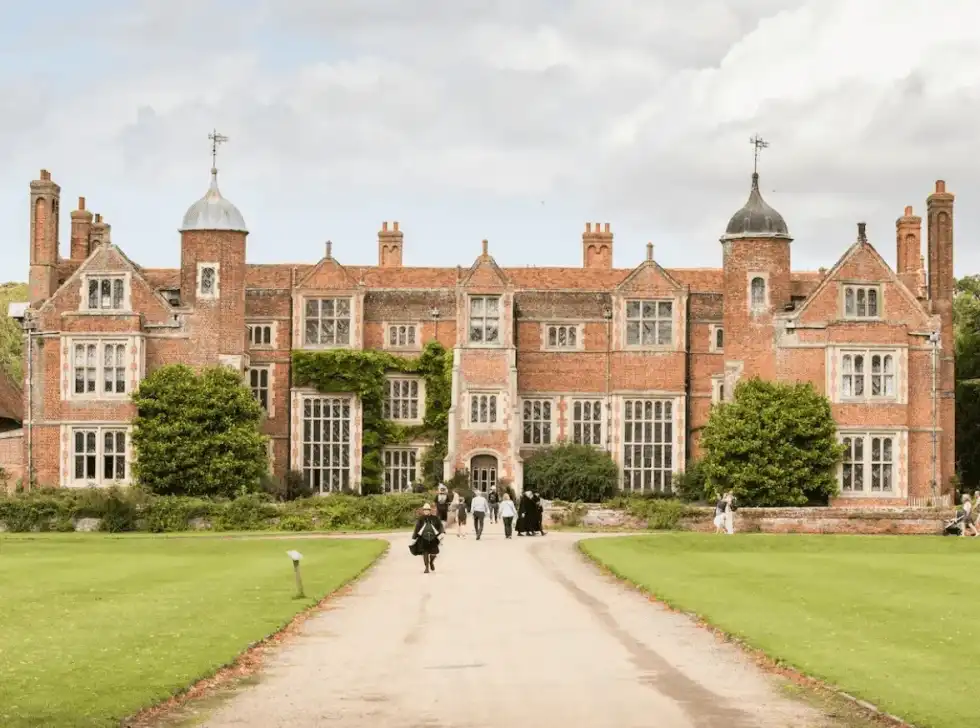 The front of Kentwell Hall and the vibrant lawns surrounding it.