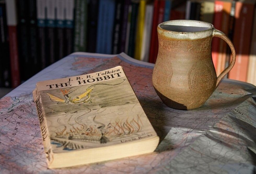 The Hobbit book sitting on a table with a fictional map