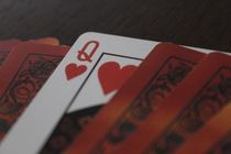 The queen in a deck of cards is a playing card with a queen image on it. A queen is usually ranked between the king and the jack in playing cards.