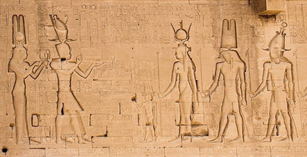 The south wall of the temple of Hathor at Dendera with lion-headed waterspouts. Cleopatra and her son Caesarian (on the left side).