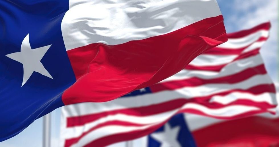 The Texas state flag waving along with the national flag of the United States of America. 