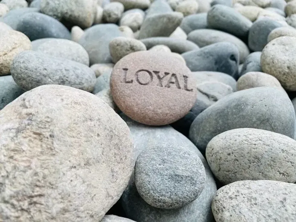 The word loyal engraved onto a rock