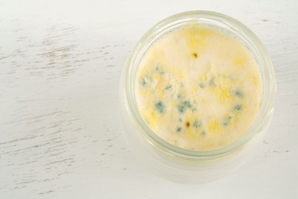 Top view of rotten moldy yogurt.