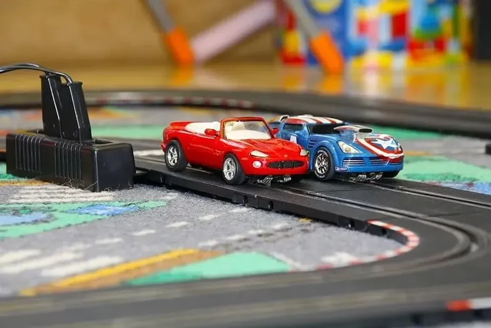 Toy cars positioned beside each other on a race track