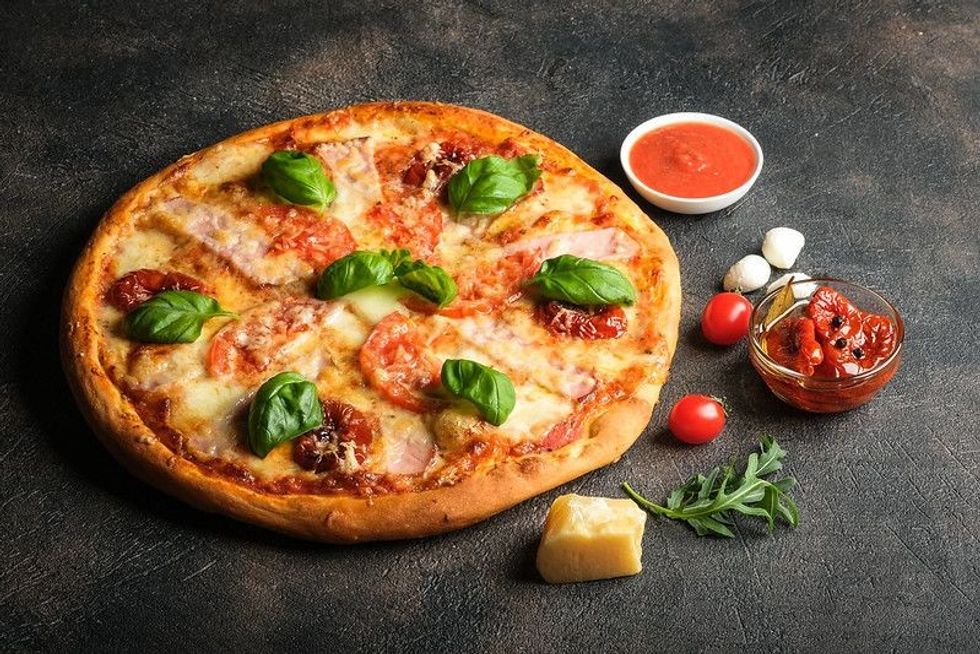 Traditional Italian pizza on a dark background.
