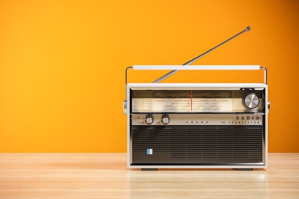 Transistor radio receiver on a wood table.
