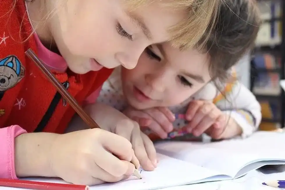 Two girls studying and working hard together. 