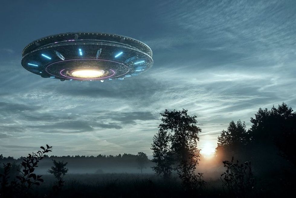 UFO, an alien plate hovering over the field.