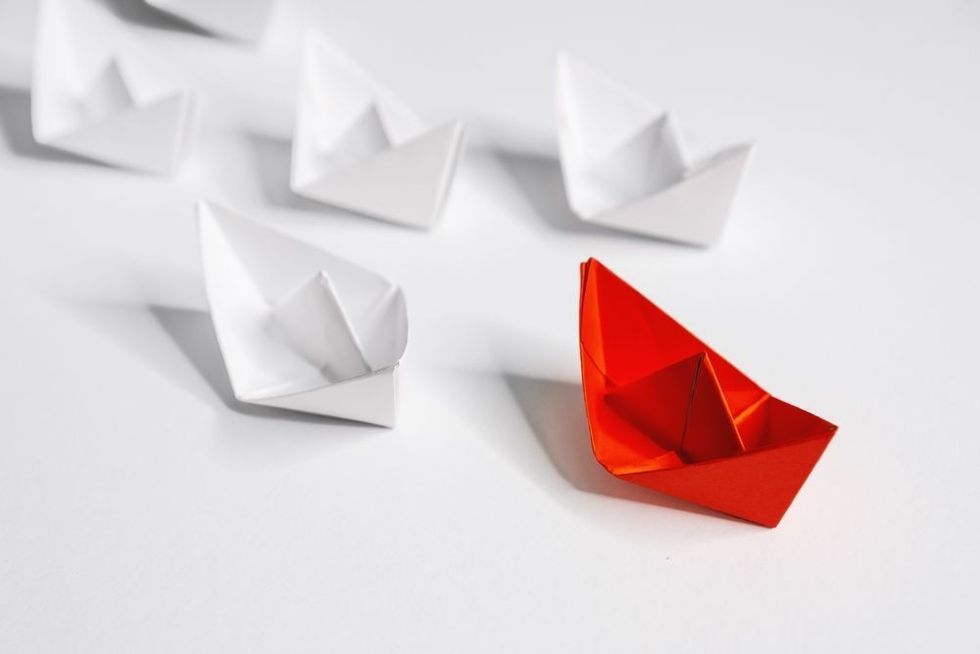 Unique Paper Boat Leading The Rest By Example.