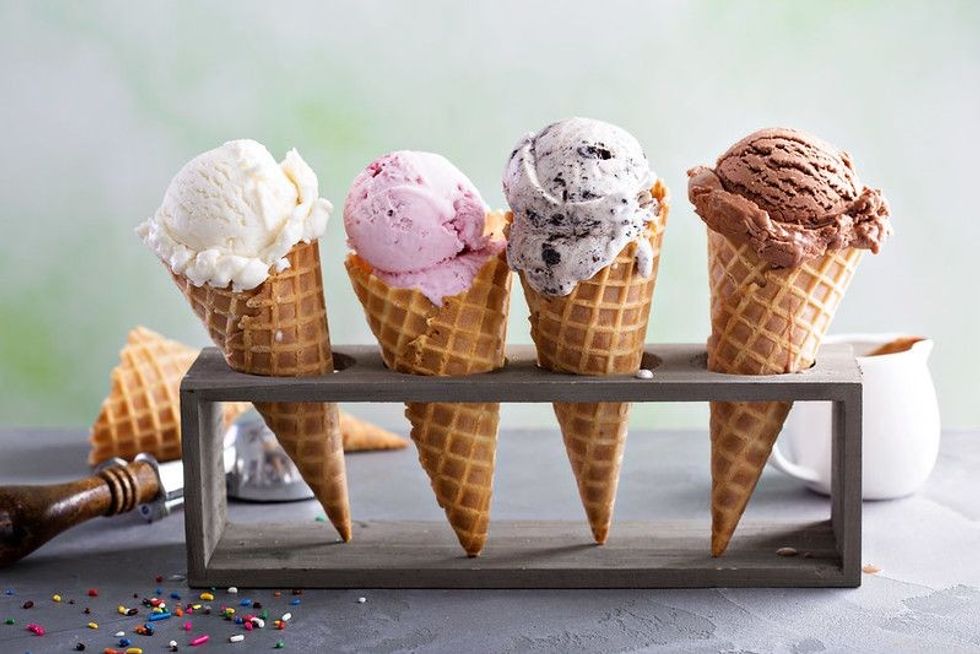 Variety of ice cream scoops in cones.