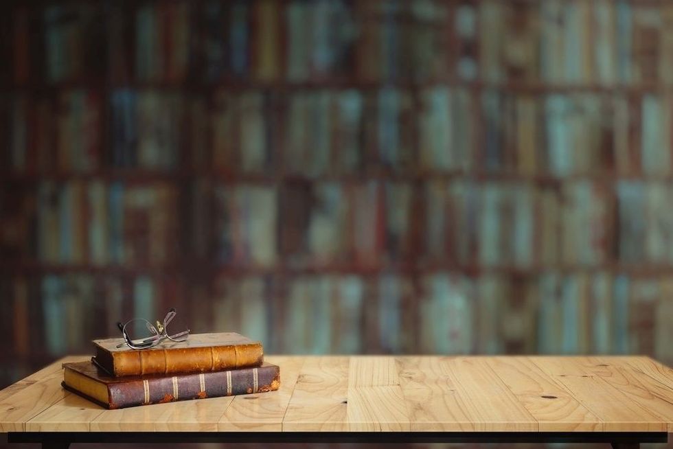 Vintage books on table in library.