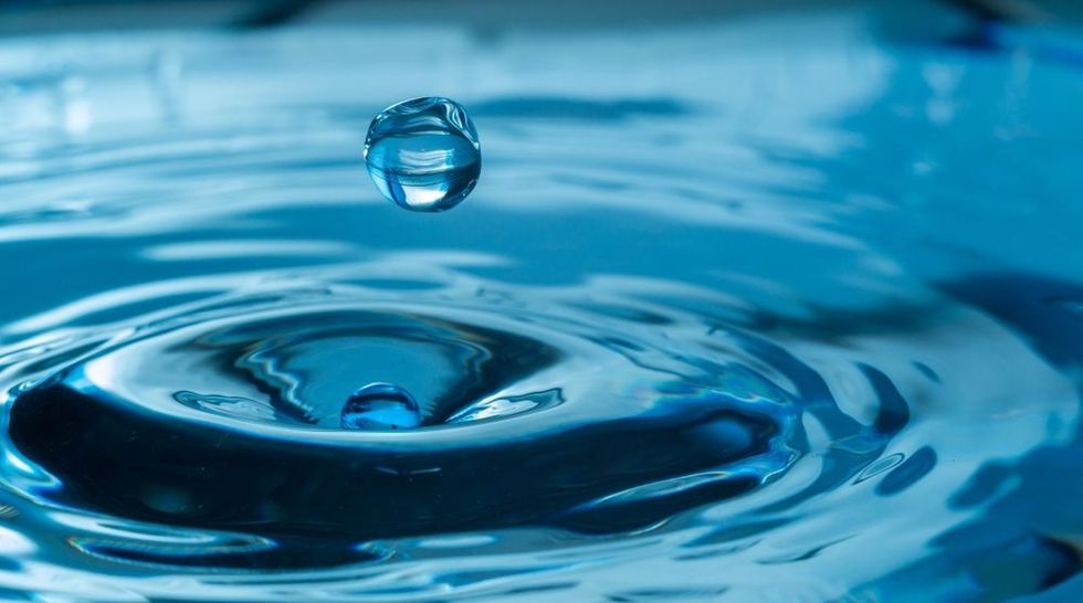 water drop splash in a glass blue colored