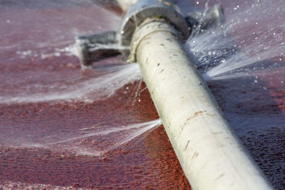 Water leaking from hole in a hose