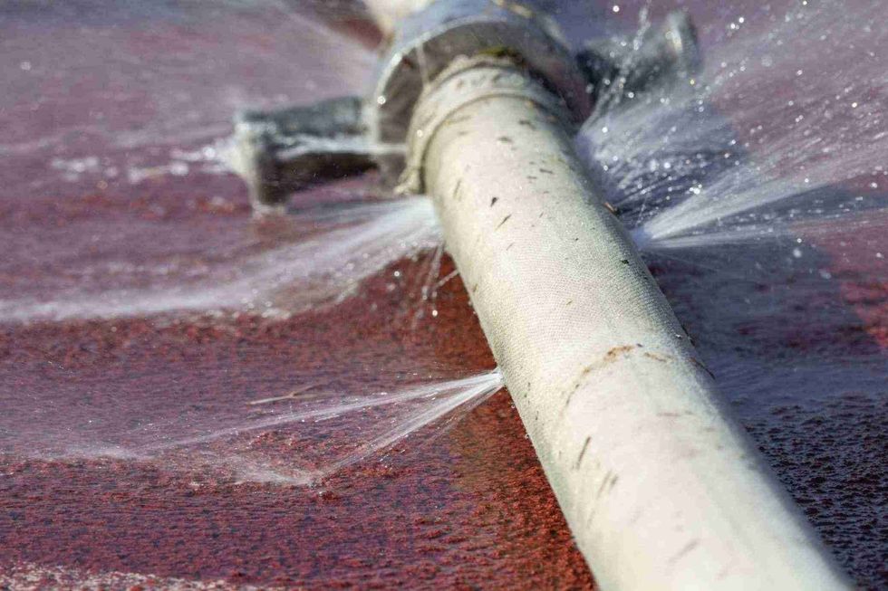 water leaking from holes in a pipe