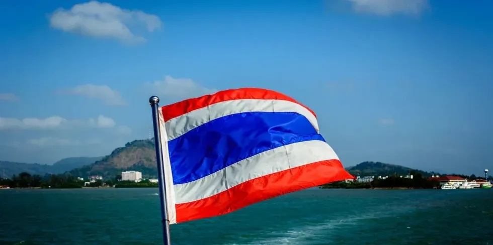 Waving Flag of Thailand on a boat in water