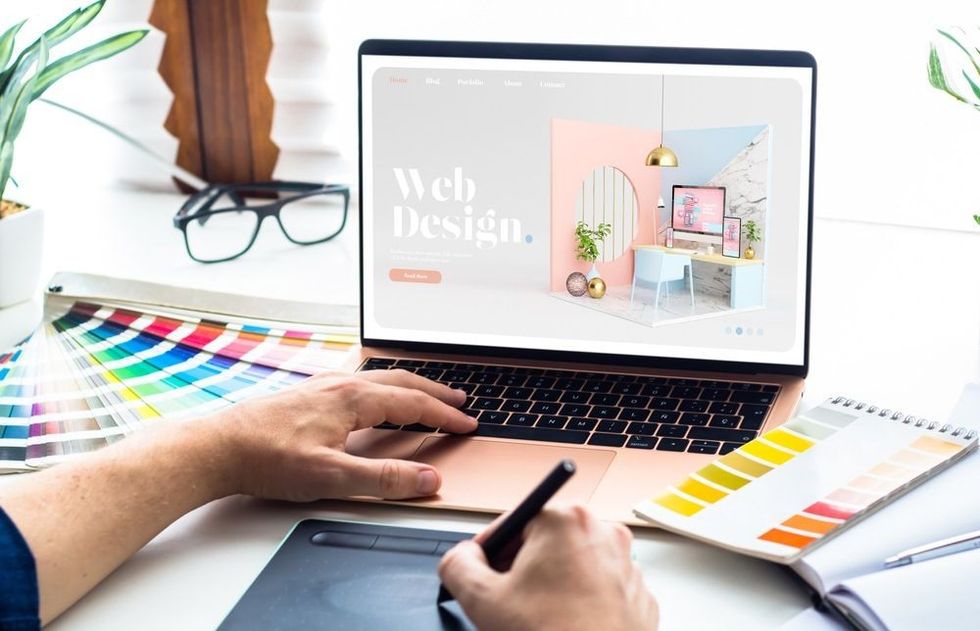 Web design desktop with laptop and tools.