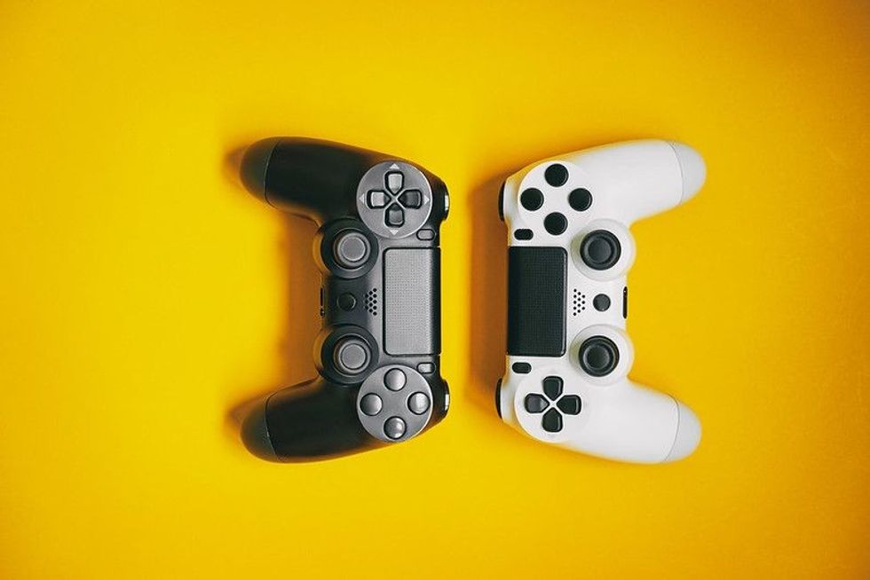 White and black joystick on yellow background.