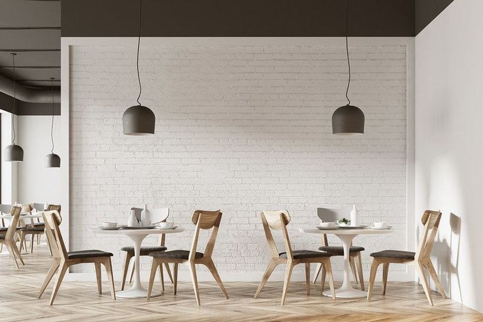 White cafe interior with a wooden floor