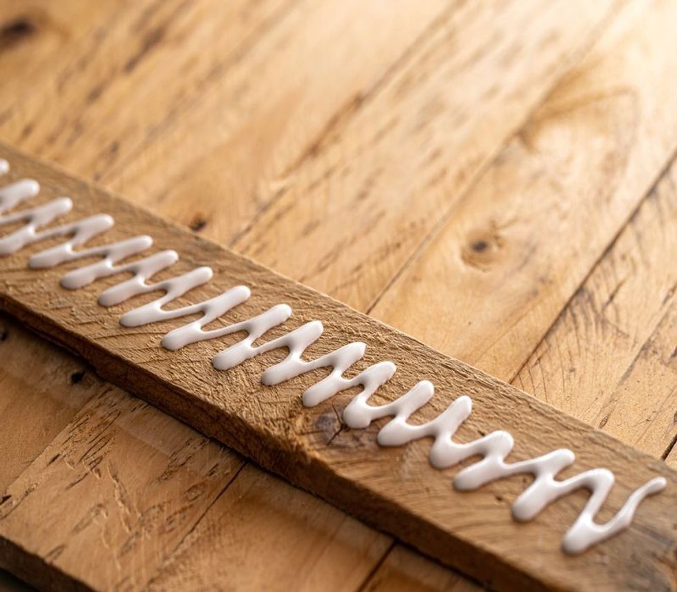 White glue on a wooden board.