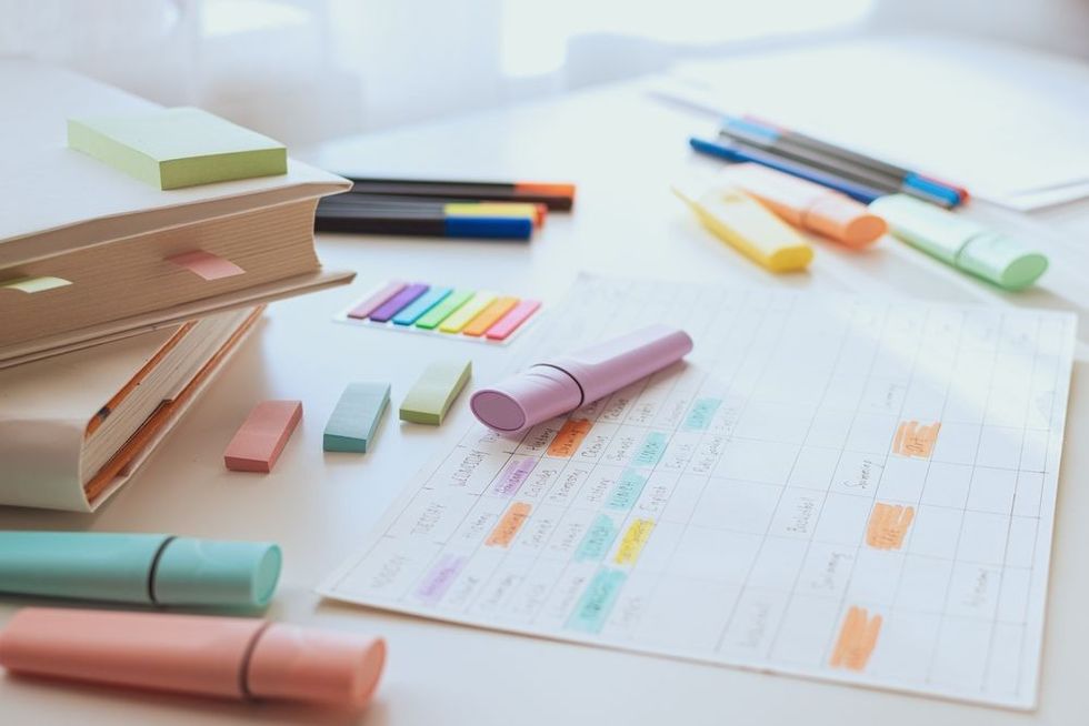 White study table with books and a weekly schedule