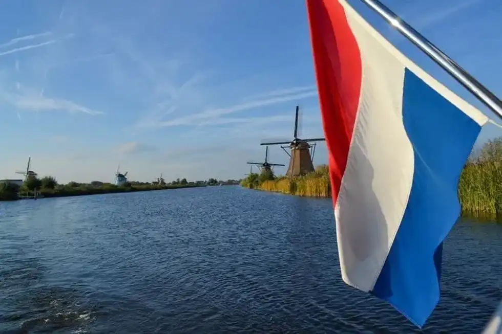 Windmills at Kinderdijk, Netherlands with the Dutch flag