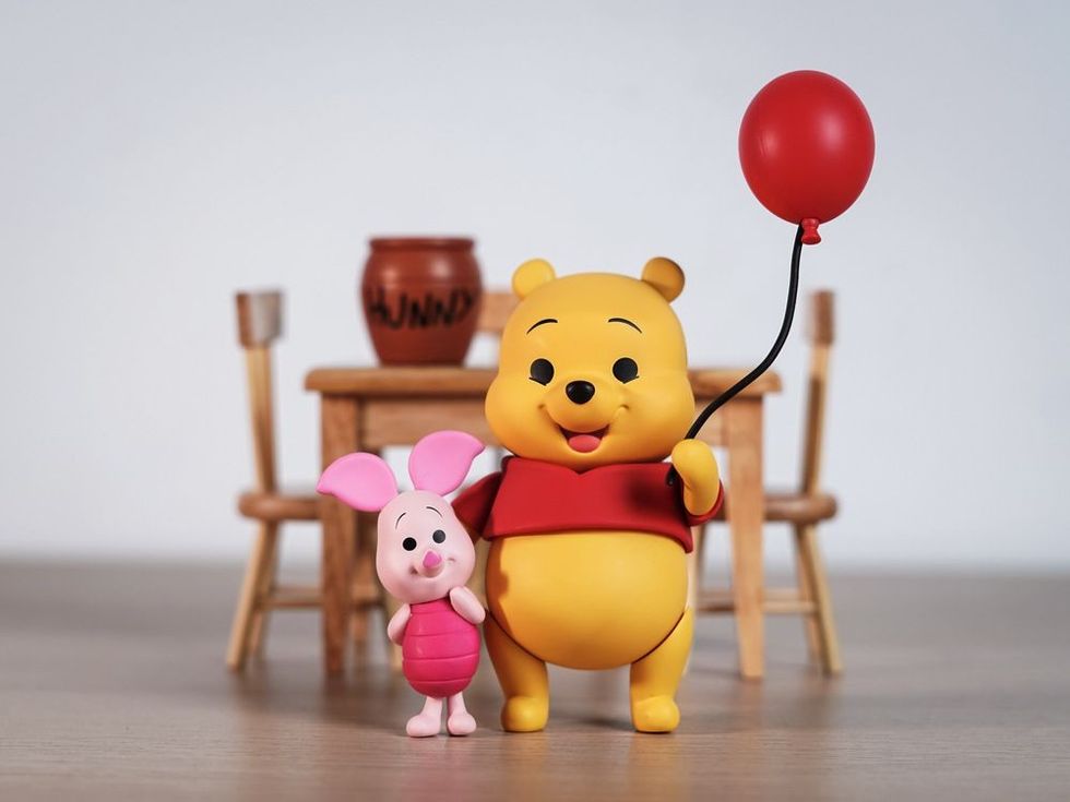 Winnie the Pooh and Piglet come out to greet everyone.
