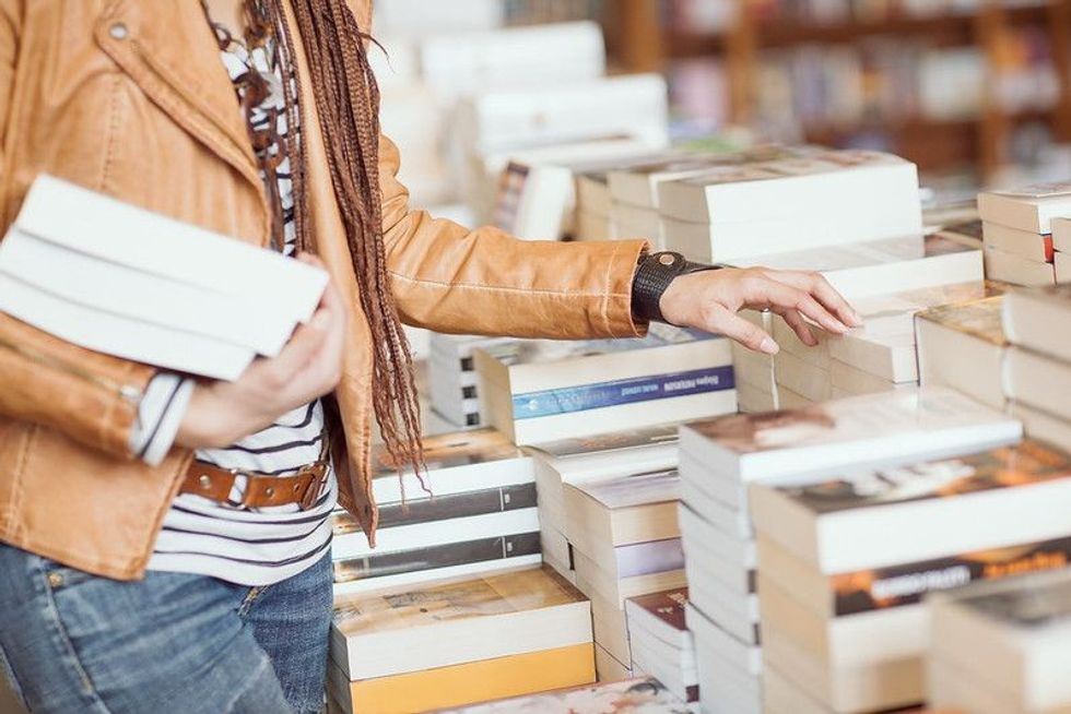 Woman buying books from a book store.