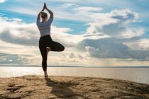 Woman practicing self discipline by meditating near a cliff edge