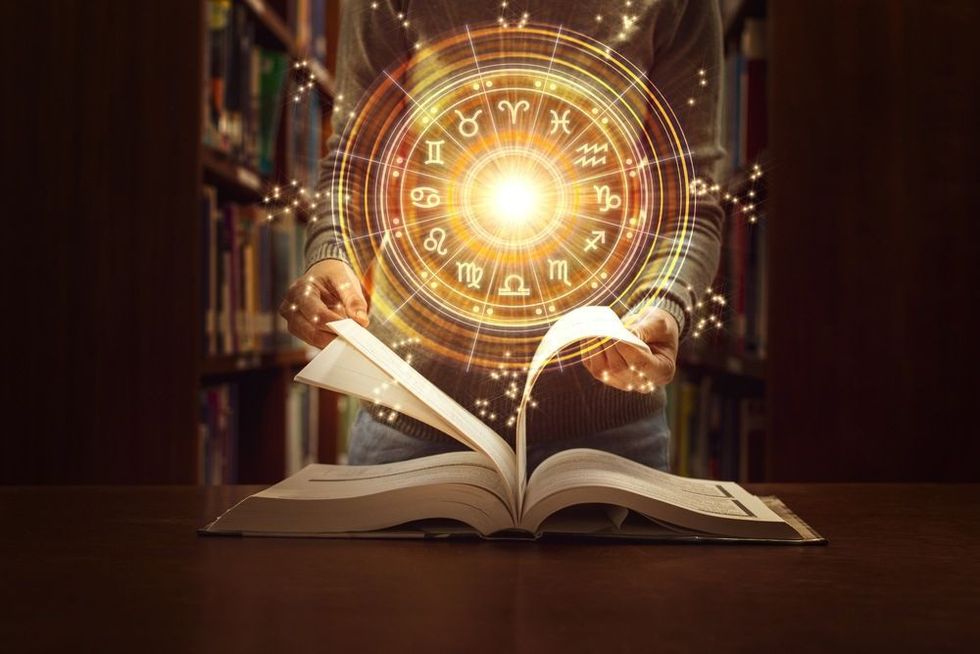 Woman reading a astrology book.