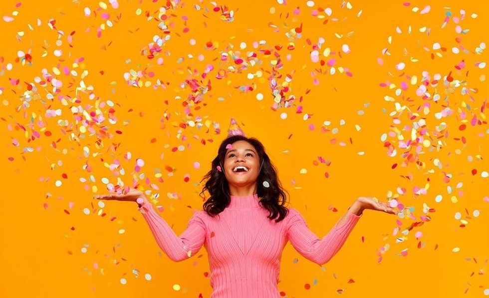 Woman standing under the colorful confetti