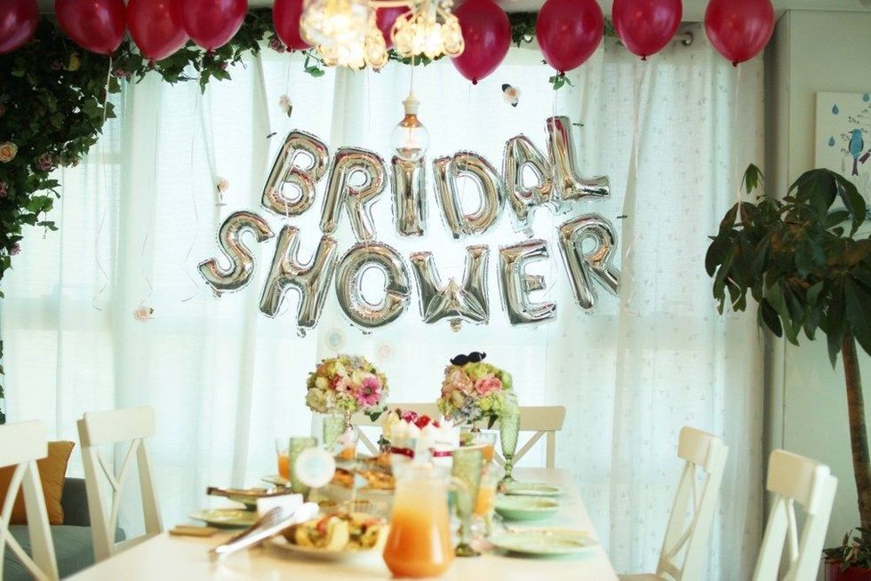 Women celebrating dessert sweets cake stand bridal shower party with friends.