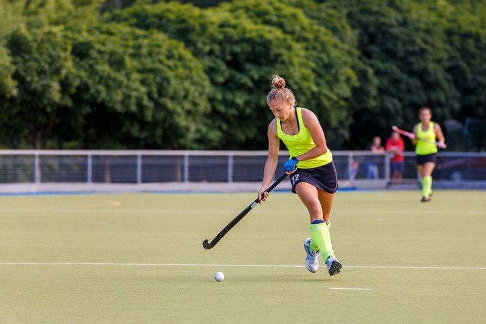 Women in the field playing hockey