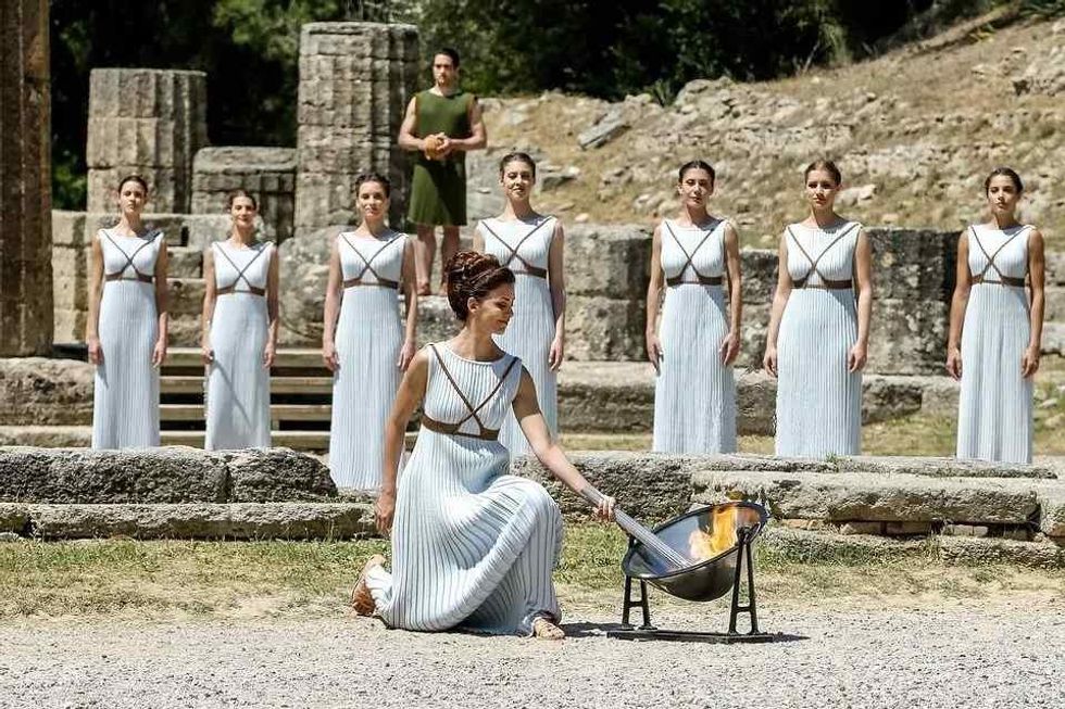 Women lighting up Olympic torch.