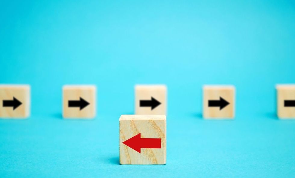 Wooden blocks with arrows showing divergence