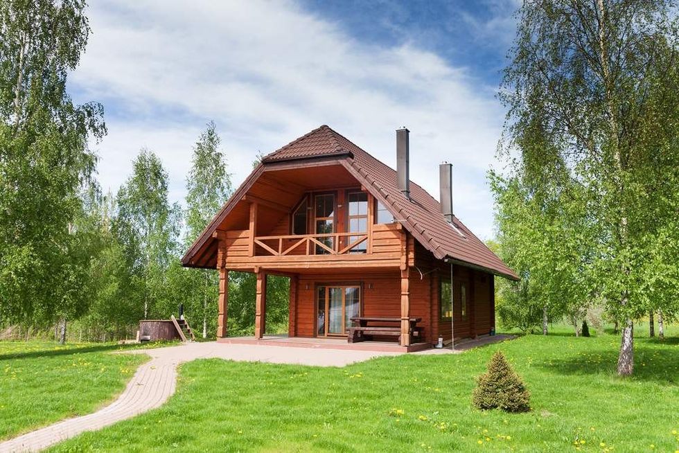 Wooden cottage on a country side.