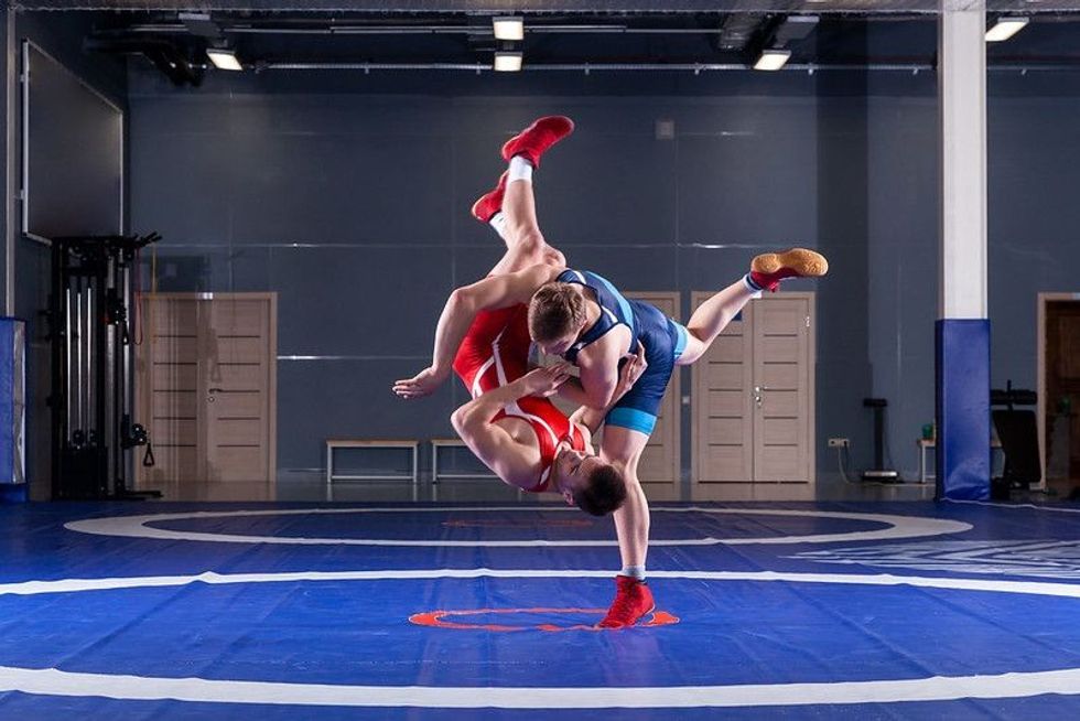 Wrestlers are wrestling to win in the ring
