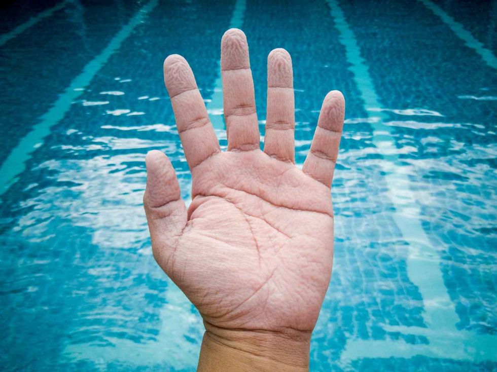 Wrinkled hand because of soaking in the water for a long time