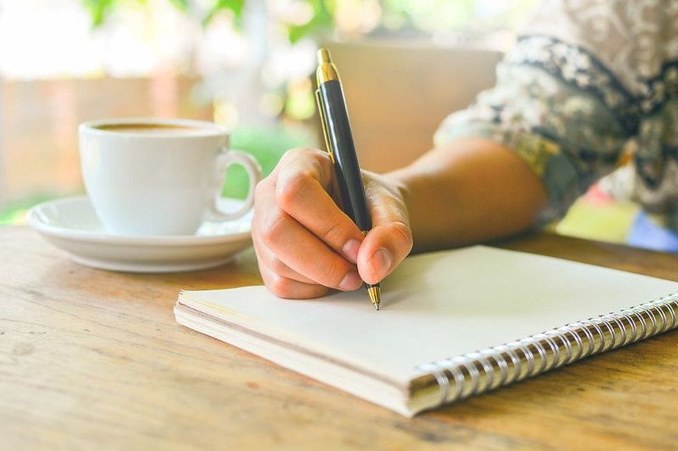 Writer writing on a notebook