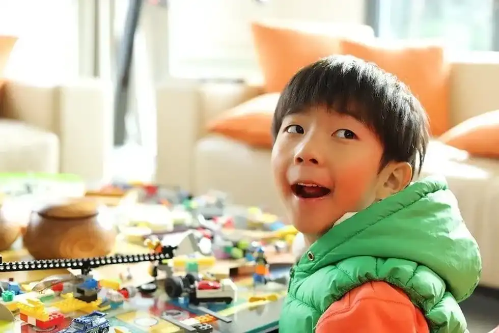 Young boy enjoying lego before making his own awesome lego candy dispenser.