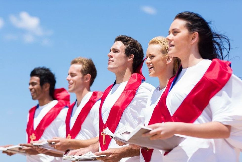 Young church choir singing outdoors