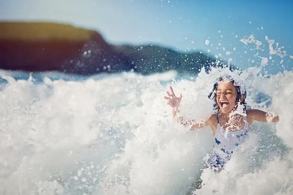 Young girl having fun in the waves.