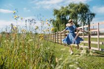 Young girl in straw hat with flowers